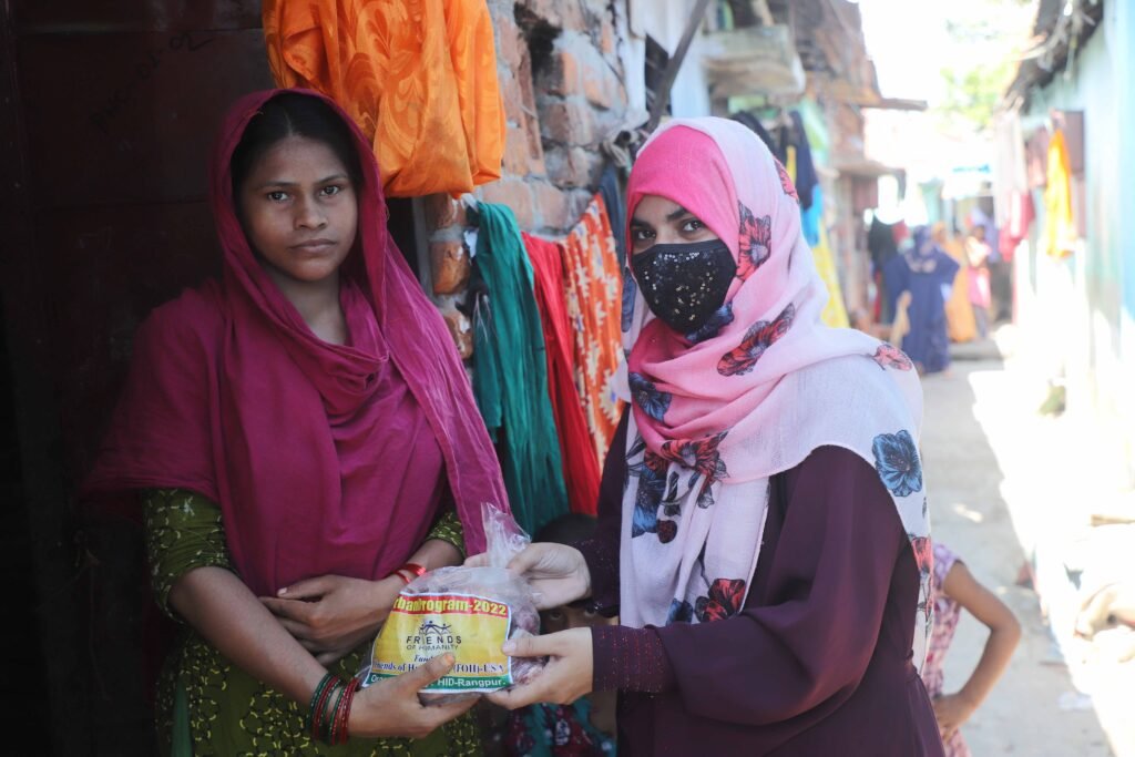 Meat is distributed among the Bodargonj Railway Camp through animal sacrifice.