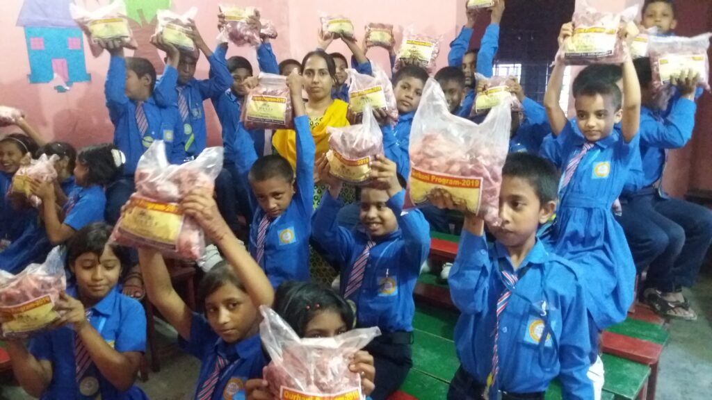 Students happily receiving bags of Qurbani meat.